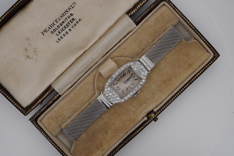 A lady's mid 20th century Swiss white metal(platinum mark) and diamond set cocktail watch with 'tumbling' Arabic numeral dial, on a 9ct white metal mesh link bracelet, case diameter 16mm, overall length 16cm, gross weigh